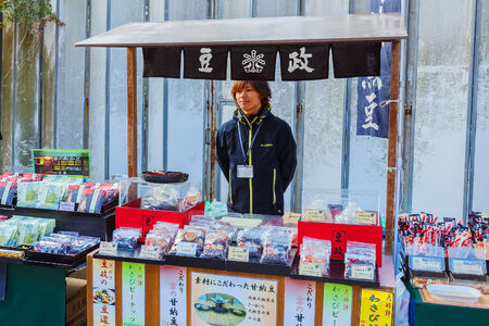 KYOTO, JAPAN - NOVEMBER 20  Japanese sweet stall in Kyoto, Japan on November 20, 2013  Unidentified man waits for customers at his sweet stall in front of Kinkaku-ji Templeのeditorial素材