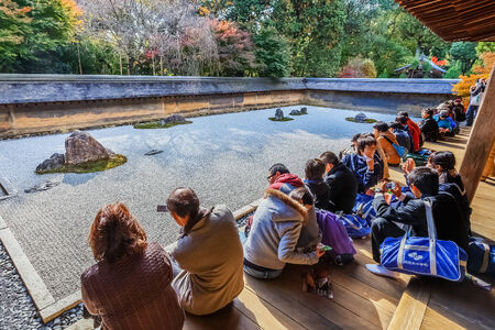 Zen Rock Garden in Ryoanji Temple in KyotoKYOTO, JAPAN - NOVEMBER 20  Ryoanji in Kyoto, Japan on November 20, 2013  A Zen Rock Garden in Ryoanji Temple in a garden with fifteen stones on white gravelのeditorial素材
