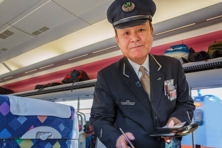 Tokyo, Japan - November 22 2013  Train steward of JR train checks for ticket and makes fair adjustment for passengerのeditorial素材