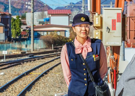YAMANASHI, JAPAN - NOVEMBER 23  Train Steward in Yamanashi, Japan on November 23, 2013  Train steward of JR train checks for ticket and makes fare adjustment for passengerのeditorial素材