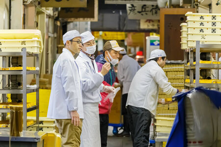 TOKYO, JAPAN - NOVEMBER 25  Tsukiji fish market in Tokyo, Japan on November 25, 2013  Unidentified japanese worker checks up food product before delivering to cutomerのeditorial素材