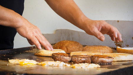 close up of hands baking hamburgerの写真素材