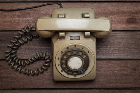 Vintage Telephone on an Old Wood Tableの写真素材