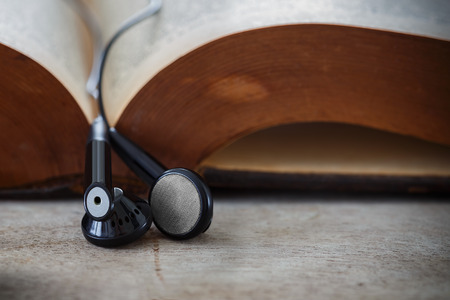 Earphones hung on an opened bookの写真素材