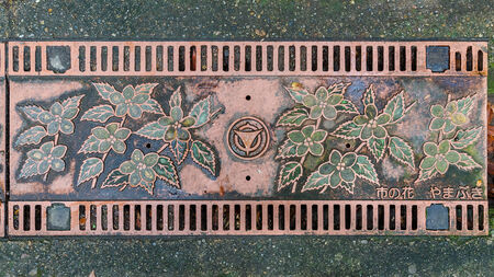 KYOTO, JAPAN - OCTOBER 21:  Manhole cover in Kyoto, Japan on October 21, 2014. Flowers and leaves design on a manhole cover on the way to Ujikami-jinja Shrine in Uji districtのeditorial素材