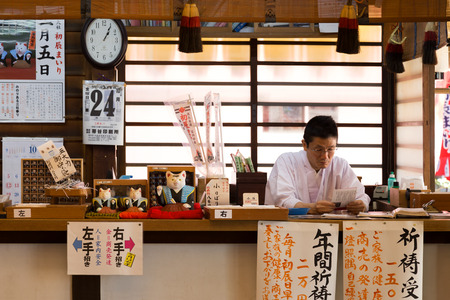OSAKA, JAPAN - OCTOBER 24: Japanese Priest in Osaka, Japan on October 24, 2014. Unidentified \"Onmyji\" or Japanese Priest is working on paper work at Sumiyoshi Grand Shrine in Osakaのeditorial素材