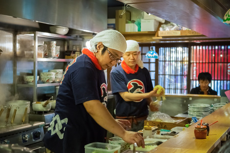 HIMEJI, JAPAN - OCTOBER 25: Japanese Ramen chef in Himeji, Japan on October 25, 2014. Unidentified Japanese  ramen chef prepares a bowl of ramen noodles for customerのeditorial素材