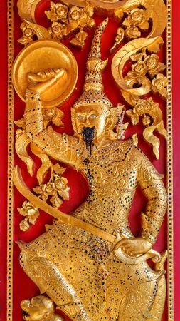 Low Reliefe on the door of Wat Bovorn Bowon Nivet Viharn in Bangkok, Thailandの写真素材