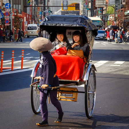TOKYO, JAPAN - NOVEMBER 15, 2015: Unidentified rickshaw drivers with passengers in Asukusa station nearby Sumida riverのeditorial素材
