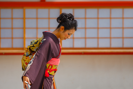 JAPAN - NOVEMBER 22 2015: Beautiful Japanese ladies in traditional kimono dress at Heian-jingu shrine, kyotoのeditorial素材