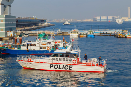 YOKOHAMA, JAPAN - NOVEMBER 24 2015: Unidentified Japanese marine police force with watercraft on duty at Yokohama portのeditorial素材