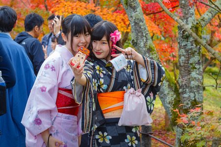 KYOTO, JAPAN - NOVEMBER 22 2015: Unidentified young Japanese women take selfie with a mobilephoneのeditorial素材