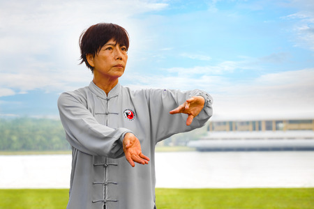 BANGKOK, THAILAND - FEBRUARY 20, 2016: Unidentified group of people practice Tai Chi Chuan in a parkのeditorial素材