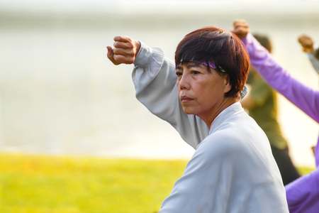 BANGKOK, THAILAND - FEBRUARY 13, 2016: Unidentified group of people practice Tai Chi Chuan in a parkのeditorial素材