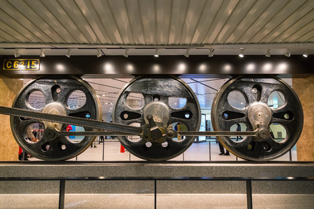 TOKYO, JAPAN - NOVEMBER 26 2015: Wheels of Japanese Historical C6215 train displayed in Tokyo Stationのeditorial素材