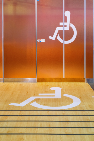 Handicap Sign in front of a Public Toiletの写真素材