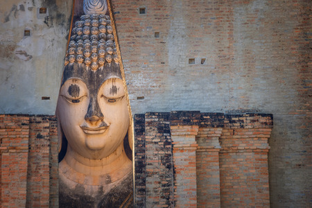 Seated Buddha image at  Wat Si Chum temple in Sukhothai Historical Park, a UNESCO world heritage site, Thailandの写真素材
