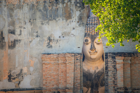Seated Buddha image at  Wat Si Chum temple in Sukhothai Historical Park, a UNESCO world heritage site Thailandの写真素材
