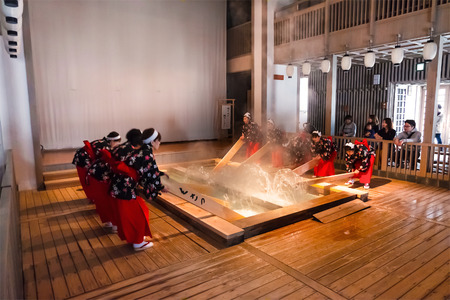 GUNMA, JAPAN - APRIL 27 2018: Yumomi is a traditional way to cool down Kusatsu's hot spring water to...