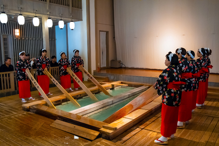 GUNMA, JAPAN - APRIL 27 2018: Yumomi is a traditional way to cool down Kusatsu's hot spring water to bathing temperature without diluting it with cold waterのeditorial素材