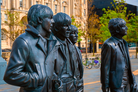 Liverpool, UK - May 17 2018: Bronze statue of the  Beatles stands at the Pier Head on the side of River Mersey, sculpted by Andrew Edwards and erected in December 2015のeditorial素材