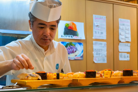 Tokyo, Japan - April 26 2018: Unidentified Japanese sushi chef prepares dishes of japanese traditional sushi sets in a restaurantのeditorial素材