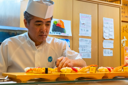 Tokyo, Japan - April 26 2018: Unidentified Japanese sushi chef prepares dishes of japanese traditional sushi sets in a restaurantのeditorial素材