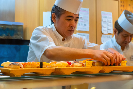 Tokyo, Japan - April 26 2018: Unidentified Japanese sushi chef prepares dishes of japanese traditional sushi sets in a restaurantのeditorial素材