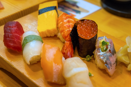 A set of japanese traditional sushi set  beautifully decorated on a wood plateの写真素材