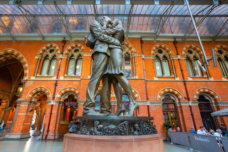 London, UK - May 14 2018: The Meeting Place, 9-metre bronze statue revealed in 2007, stands at the south end of the upper level of St Pancras railway station by British artist Paul Dayのeditorial素材
