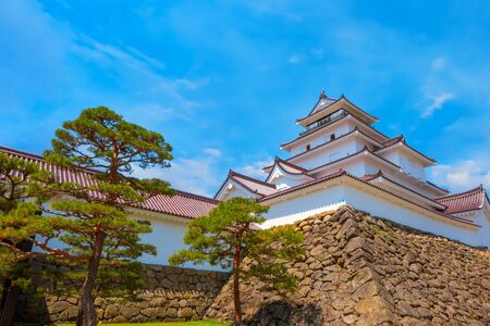 Aizuwakamatsu Castle and cherry blossom in Fukushima, Japan Aizuwakamatsu , Japan - April 21 2018: Aizu-Wakamatsu Castle and cherry blossom built by Ashina Naomori in 1384, Tenshu, the largest tower was reconstructed in 1965 in concreteのeditorial素材