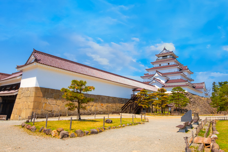 Aizuwakamatsu Castle and cherry blossom in Fukushima, Japan Aizuwakamatsu , Japan - April 21 2018: Aizu-Wakamatsu Castle and cherry blossom built by Ashina Naomori in 1384, Tenshu, the largest tower was reconstructed in 1965 in concreteのeditorial素材