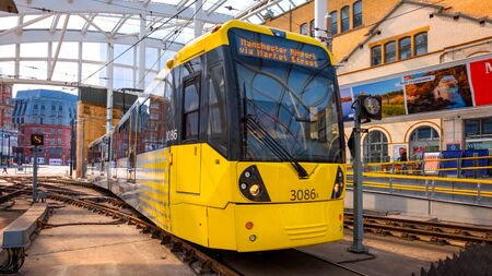 Manchester, UK - May 18 2018: Light rail Metrolink tram in the city center of Manchester, UK. The system has 77 stops along 78.1 km and runs through seven of the ten boroughsのeditorial素材