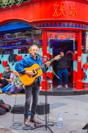 London, UK - May 13 2018: Unindentified  street musician performs in London Chinatown at Gerrard Streetのeditorial素材