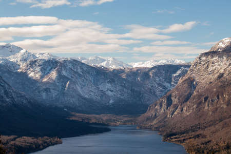 Bohinj lake with snowy mountains in autumnの写真素材