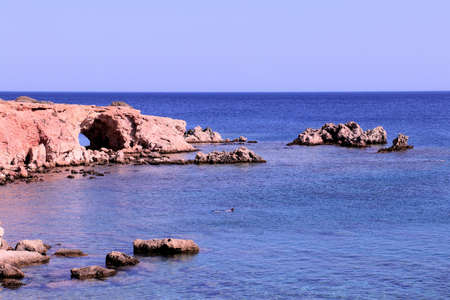 hole through rock formation in karpathos