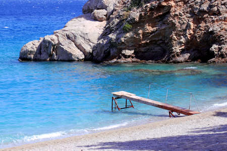 turquoise water and small dock in apollo beachの写真素材