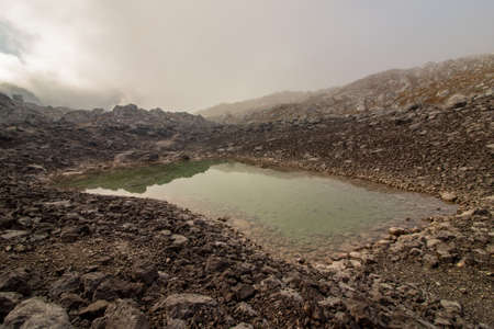 mountain lake surrounded with mist