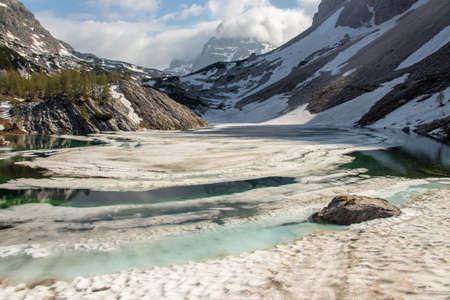 Ledvicka lake covered in snow, early summerの写真素材