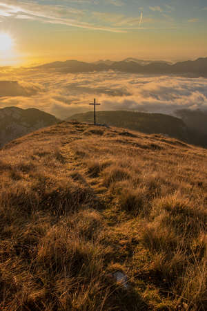 Sunrise with cross on top of a mountain, Bohinjの写真素材