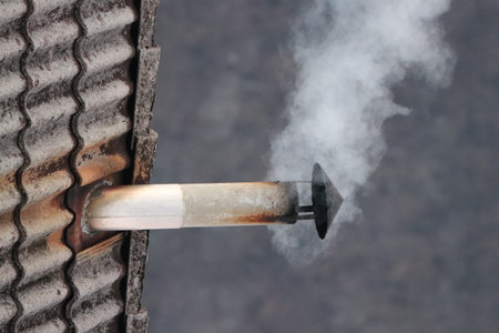 Narrow metal chimney on the rooftop, close upの写真素材