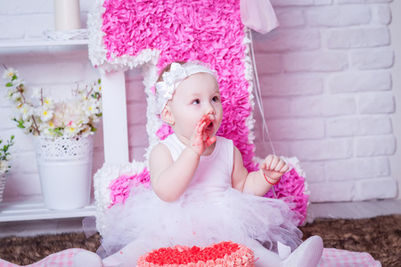Little girl eating cakeの写真素材