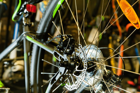 Disc brake on a black bicycle in the light of a flashlightの写真素材