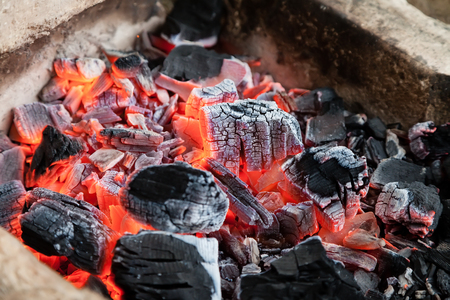 Burning hot coals lie in the fire and smolderの写真素材