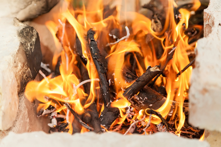 Burning brushwood in a hot open fireの写真素材