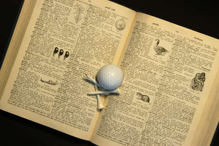 dictionary, golf ball and teesの写真素材