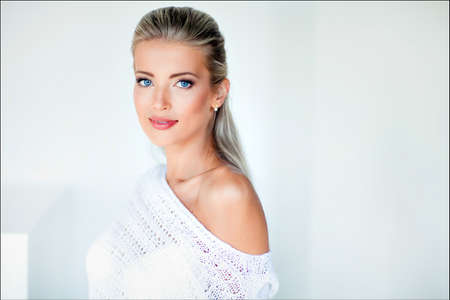 Beautiful sexy sensual blonde girl in a white jacket, Studioの写真素材