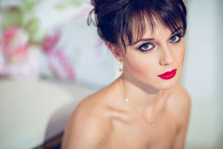 Portrait of a very beautiful girl brunette with red lipstickの写真素材