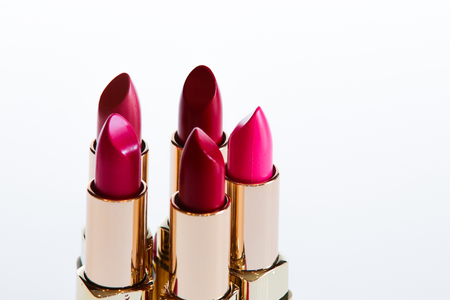 Red and pink lipsticks in white isolated backgroundの写真素材
