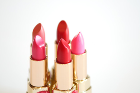 Red and pink lipsticks in white isolated backgroundの写真素材